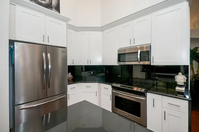 a kitchen with a refrigerator stove and microwave