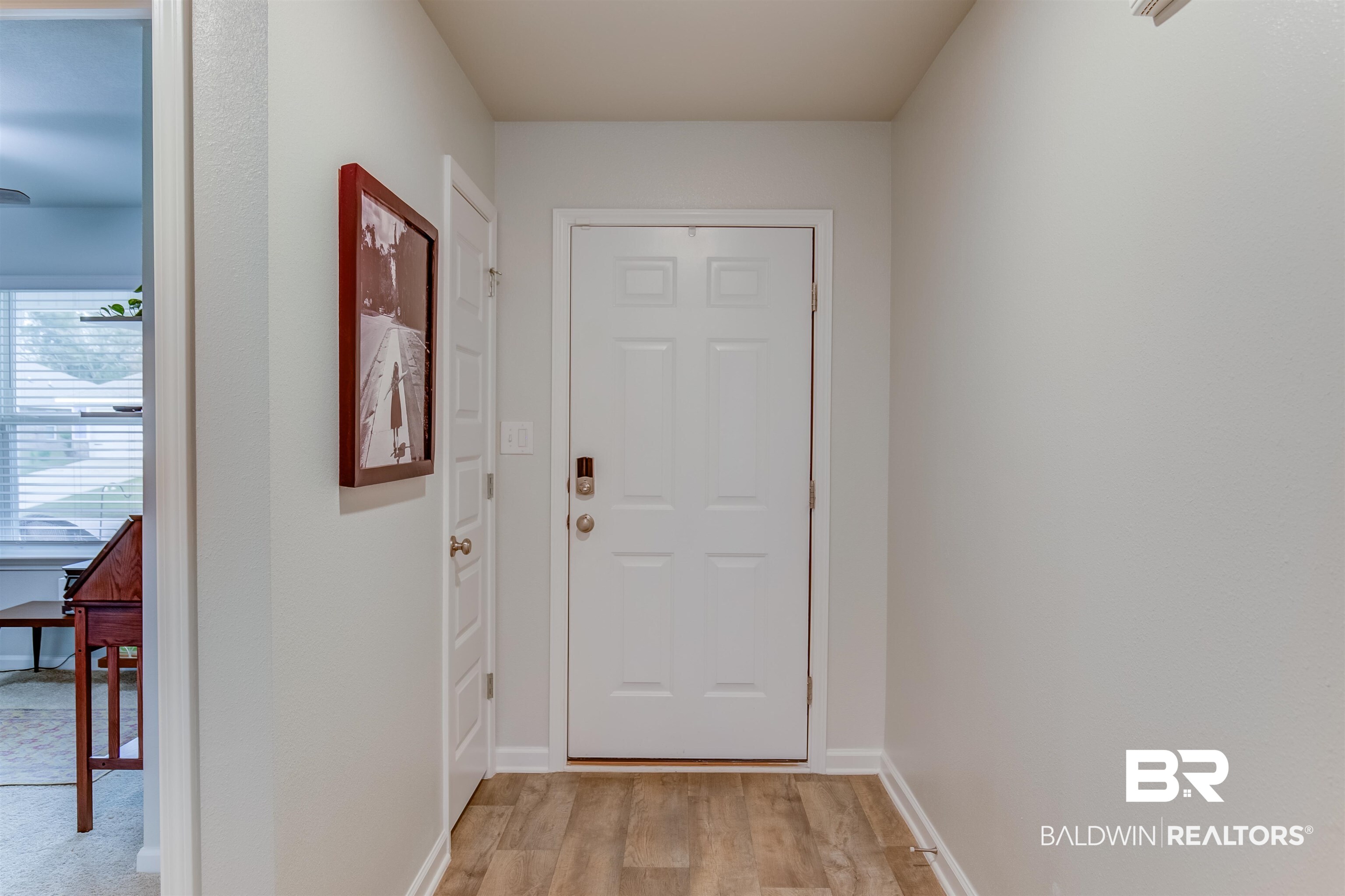 8033 Irwin Loop Daphne, AL 36526 - Photo 9 of 38 Entryway featuring wood-finish flooring, a paneled door with smart lock hardware, and light neutral wall tones