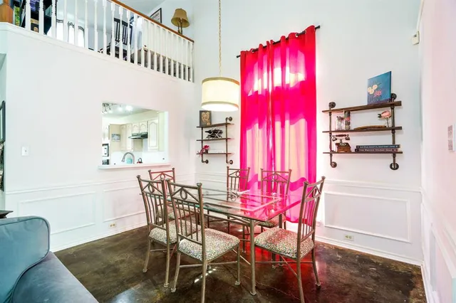 a view of a dining room with furniture and chandelier