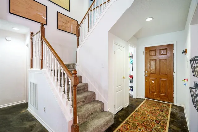 a view of an entryway with wooden floor