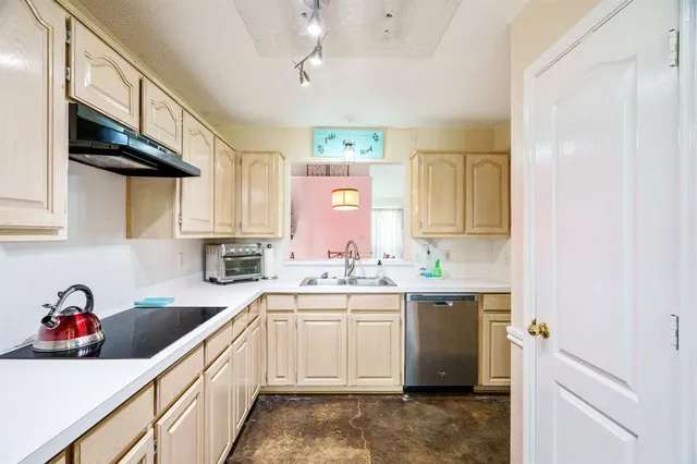 a kitchen with a sink cabinets and window