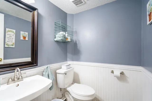 a white toilet sitting next to a bathroom sink