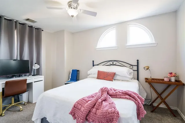 a bedroom with a bed a desk and chair