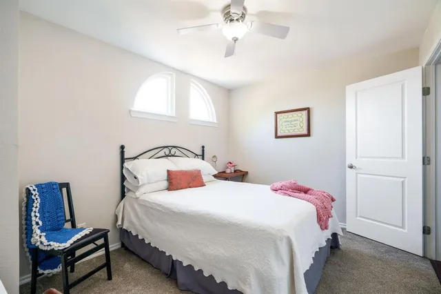 a bedroom with bed and window