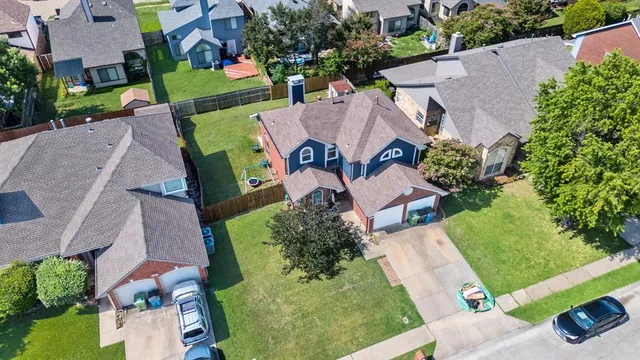 an aerial view of a house with garden space and street view