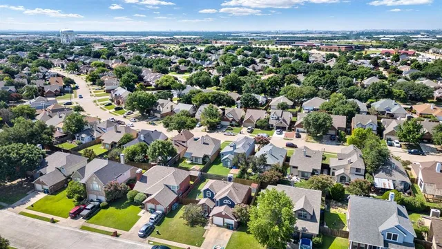 an aerial view of residential houses with outdoor space