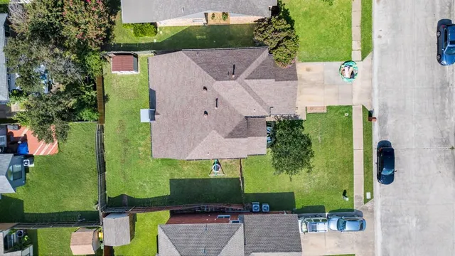an aerial view of a house with a yard