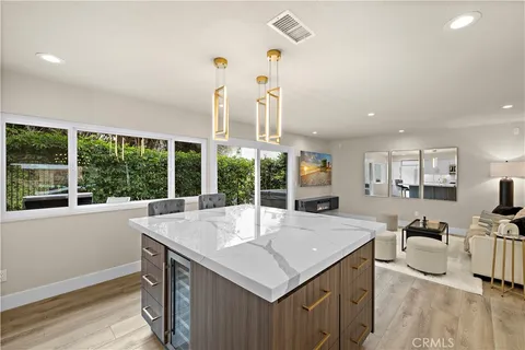a view of a living room and kitchen with a sink