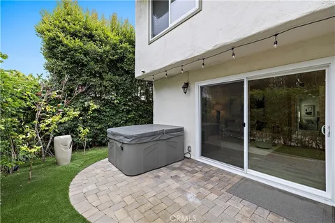 a view of a patio with table and chairs and potted plants