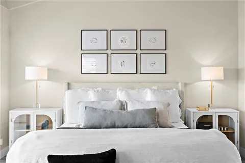 a bedroom with a large bed and a lamp on table