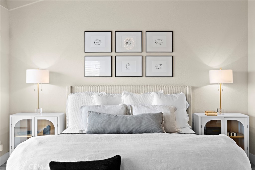 23277 Atlantis Way Dana Point, CA 92629 - Photo 25 of 48 a bedroom with a large bed and a lamp on table