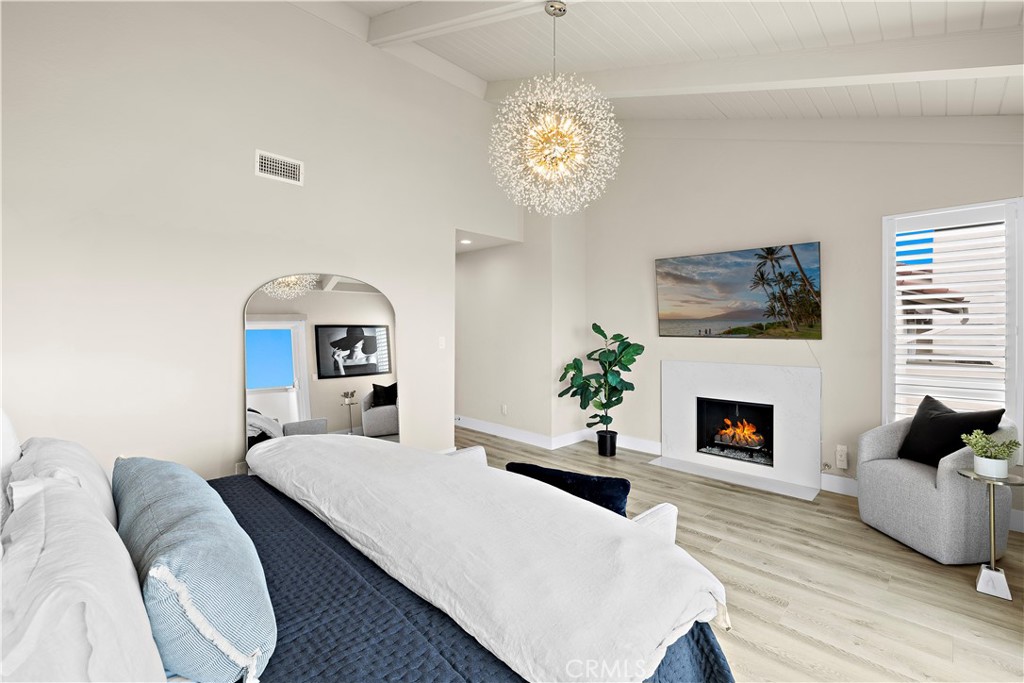 23277 Atlantis Way Dana Point, CA 92629 - Photo 26 of 48 a bedroom with a bed and a fireplace