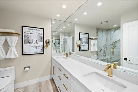 a spacious bathroom with a double vanity sink mirror and bathtub