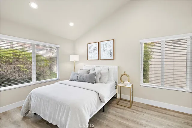 a bedroom with a large bed and a large window