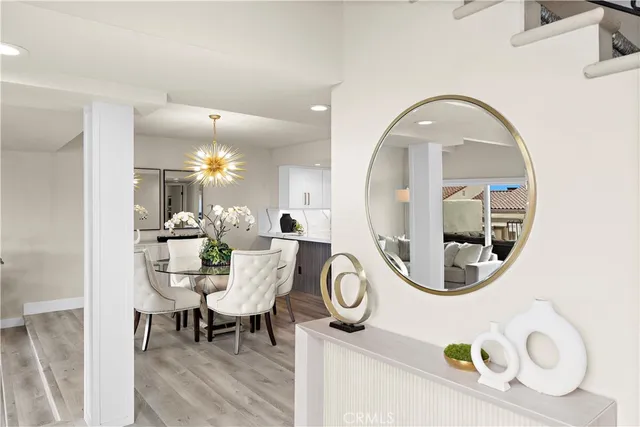 a view of a dining room with furniture and chandelier