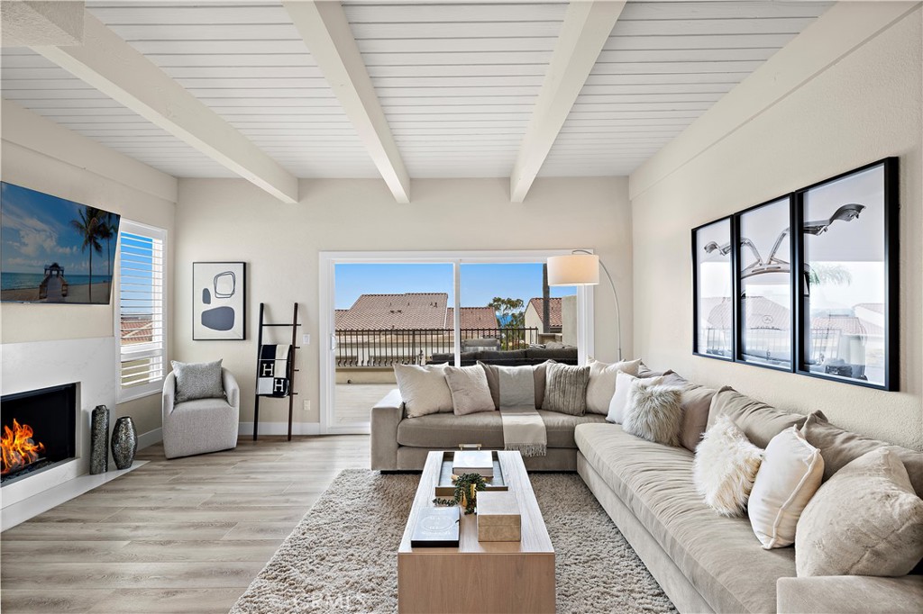 23277 Atlantis Way Dana Point, CA 92629 - Photo 9 of 48 a living room with furniture and a fireplace