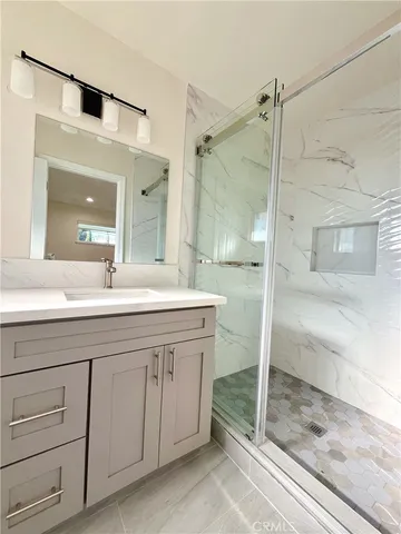a bath room with a sink and a mirror