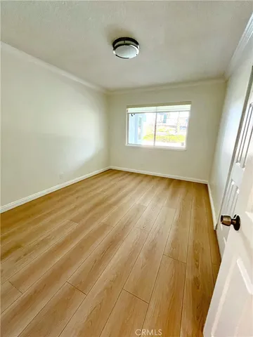 a view of a room with wooden floor and window