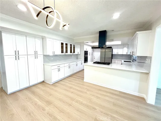 a kitchen with stainless steel appliances granite countertop a stove and a sink