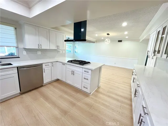 a kitchen with stainless steel appliances granite countertop a sink and a stove top oven