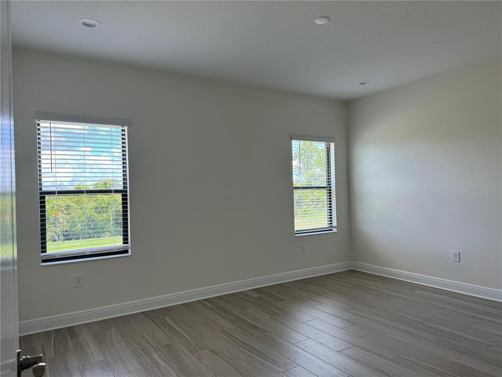 261 Potenza Loop Nokomis, FL 34275 - Photo 14 of 42 an empty room with wooden closet and windows