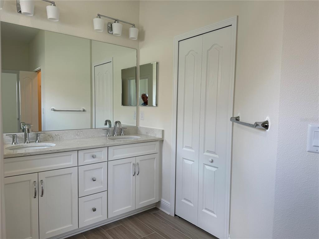 261 Potenza Loop Nokomis, FL 34275 - Photo 17 of 42 a bathroom with double sink and a mirror