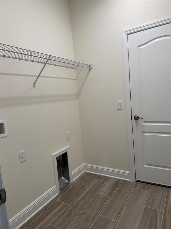 261 Potenza Loop Nokomis, FL 34275 - Photo 23 of 42 a view of an empty room with wooden floor and a window