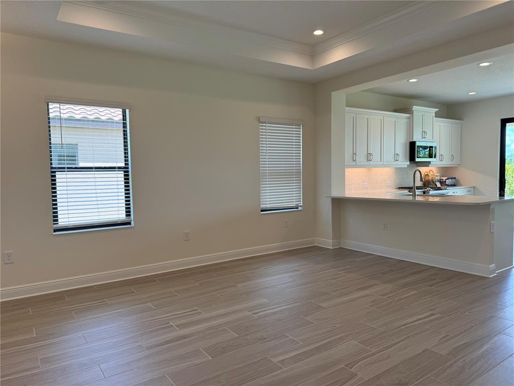 261 Potenza Loop Nokomis, FL 34275 - Photo 25 of 42 an empty room with wooden floor and windows