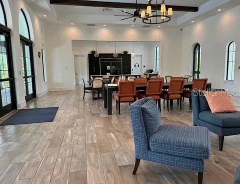 a living room with lots of furniture and view of kitchen