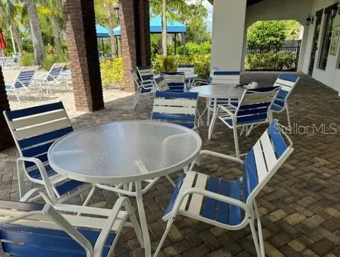 a view of a patio with table and chairs and potted plants