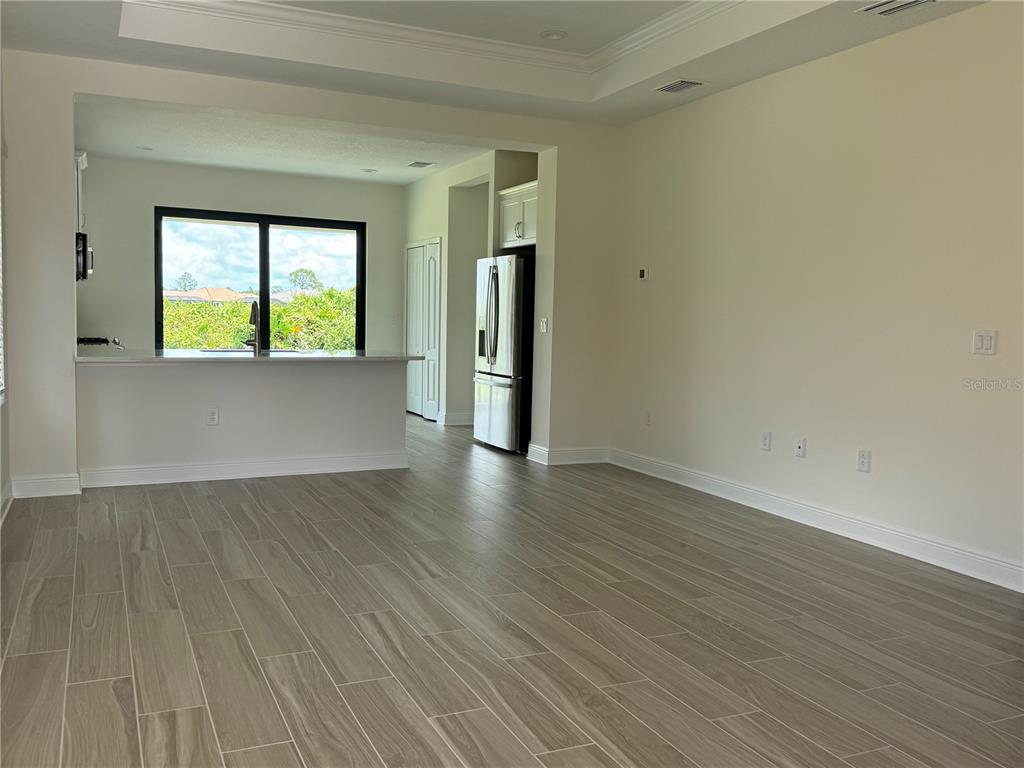 261 Potenza Loop Nokomis, FL 34275 - Photo 4 of 42 an empty room with wooden floor and windows