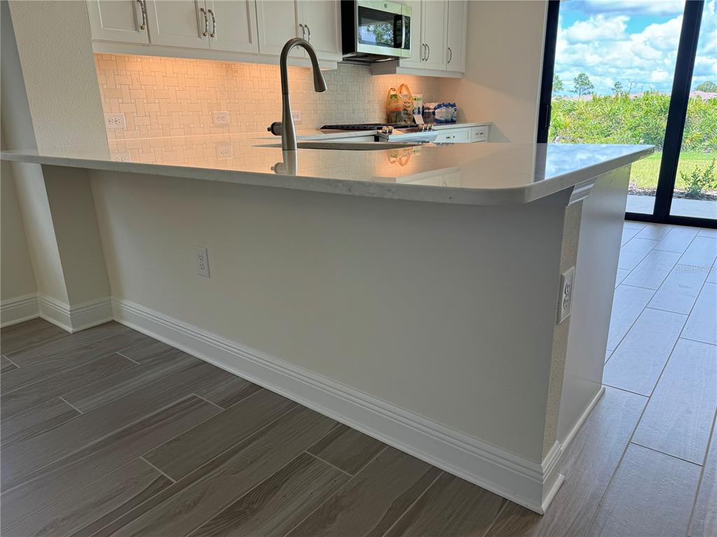 261 Potenza Loop Nokomis, FL 34275 - Photo 6 of 42 a kitchen with a sink and wooden floor