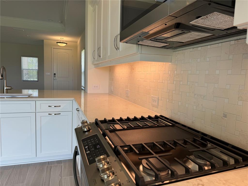 261 Potenza Loop Nokomis, FL 34275 - Photo 10 of 42 a close view of a stove a microwave and cabinets