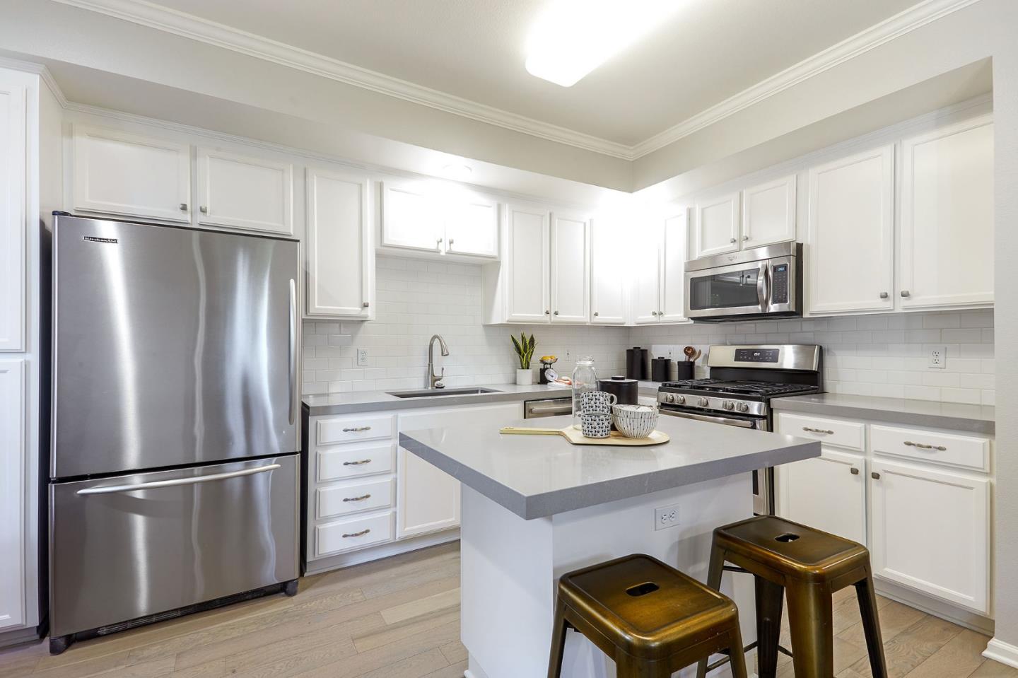 600 Willow Road, Unit 24 Menlo Park, CA 94025 - Photo 13 of 23 a kitchen with stainless steel appliances a refrigerator a stove a sink cabinets and a refrigerator