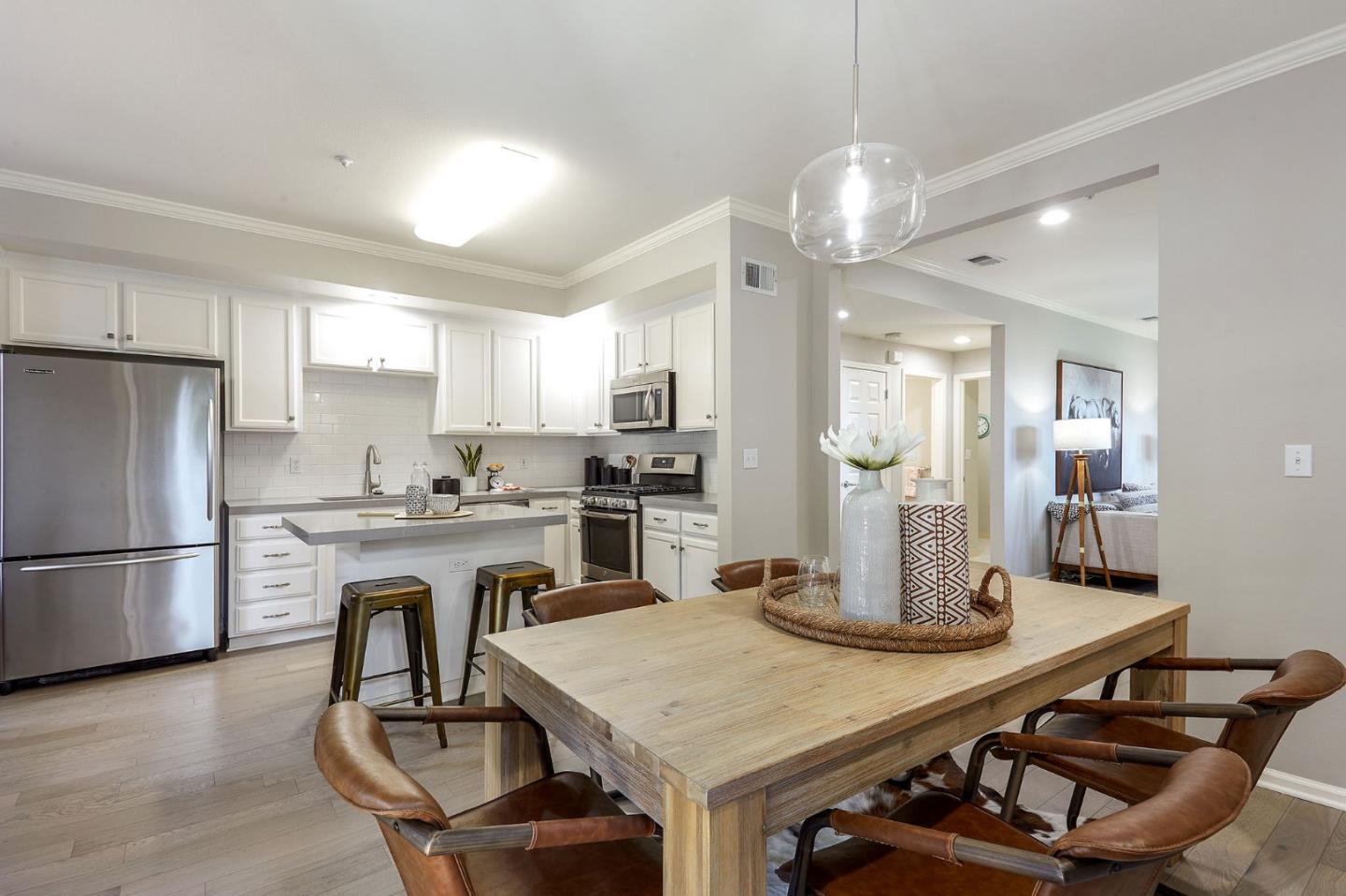 600 Willow Road, Unit 24 Menlo Park, CA 94025 - Photo 7 of 23 a kitchen with a table chairs refrigerator and microwave