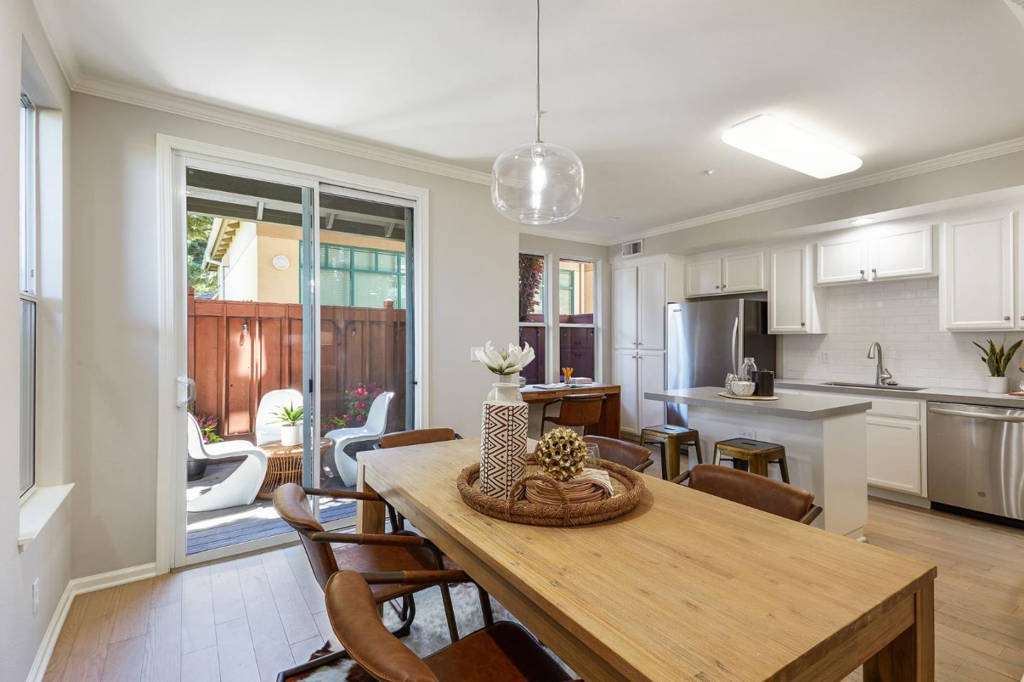 600 Willow Road, Unit 24 Menlo Park, CA 94025 - Photo 8 of 23 a kitchen with sink stove dining table and chairs
