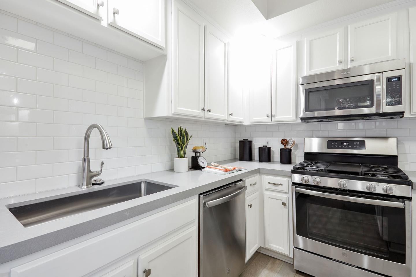 600 Willow Road, Unit 24 Menlo Park, CA 94025 - Photo 9 of 23 a kitchen with stainless steel appliances granite countertop white cabinets a stove a sink and dishwasher