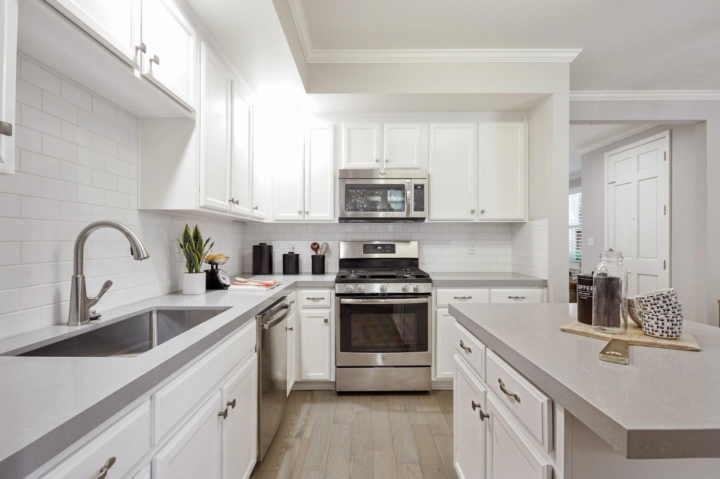600 Willow Road, Unit 24 Menlo Park, CA 94025 - Photo 10 of 23 a kitchen with white cabinets a sink and appliances