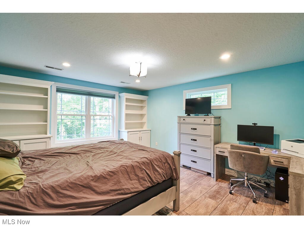 1570 Shade Road Akron, OH 44333 - Photo 20 of 45 This bedroom has built in cabinetry on both sides of the window, with LVT floors and a private bathroom.