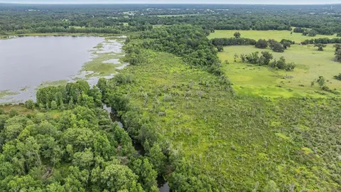 an aerial view of a houses with outdoor space and swimming pool