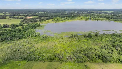 a view of a house with a backyard and a garden