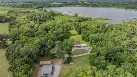 a view of a room with a chair and the trees
