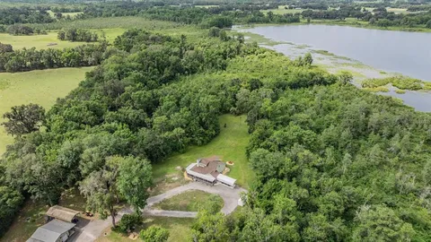 a view of a balcony with chairs and wooden floor