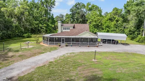 a view of a chairs and table in patio with wooden floor