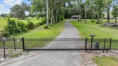 a view of a house with a backyard and a patio
