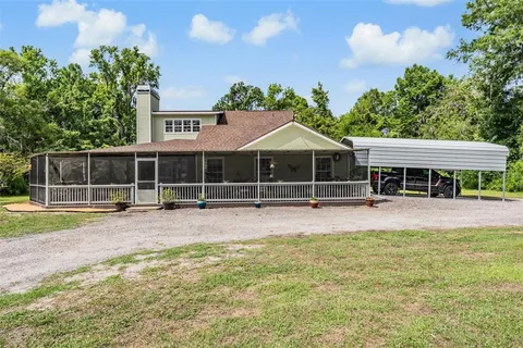 a view of a kitchen with stainless steel appliances granite countertop a sink and a refrigerator