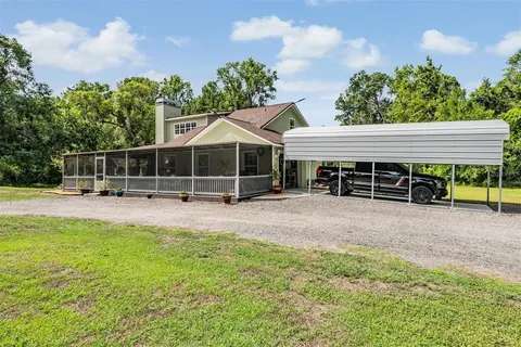 a kitchen with stainless steel appliances granite countertop a refrigerator a stove and a sink with wooden floor