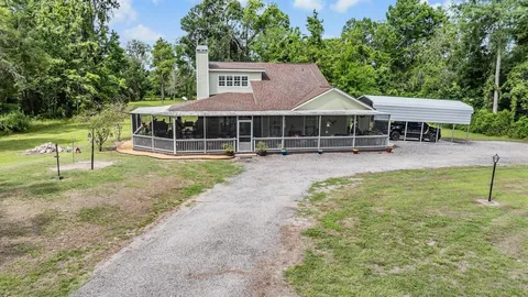 an aerial view of residential houses with outdoor space and river