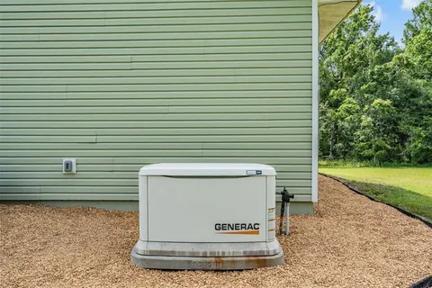 a spacious bedroom with a bed a dresser and a large window