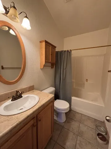 a bathroom with a sink toilet a mirror and shower